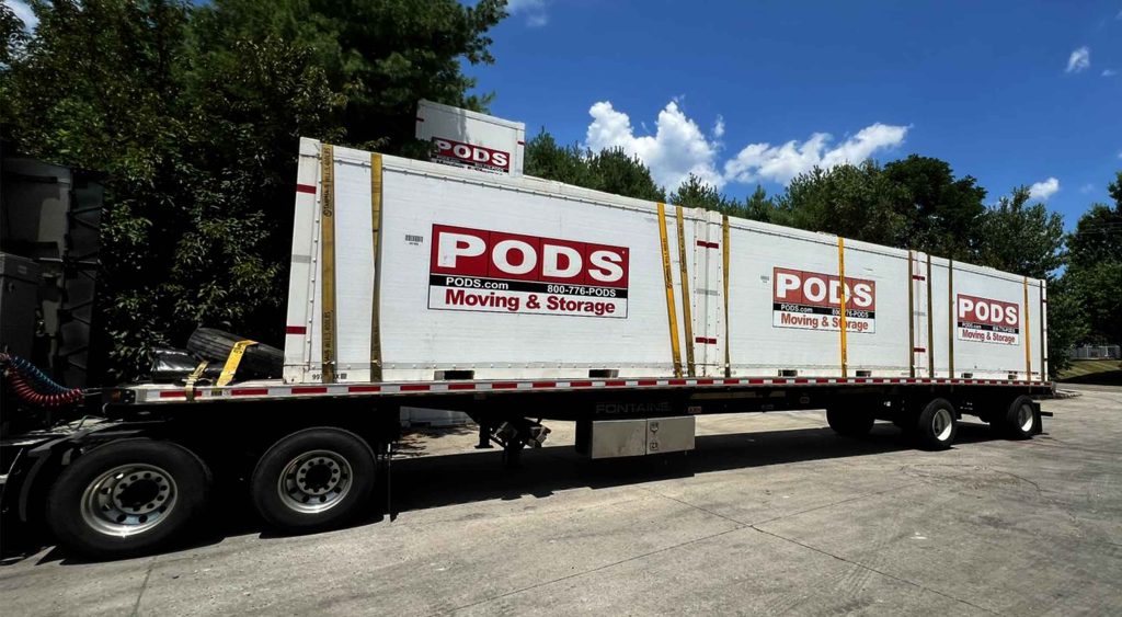 TA Trans Inc Flatbed service trailer transporting PODS moving and storage containers.