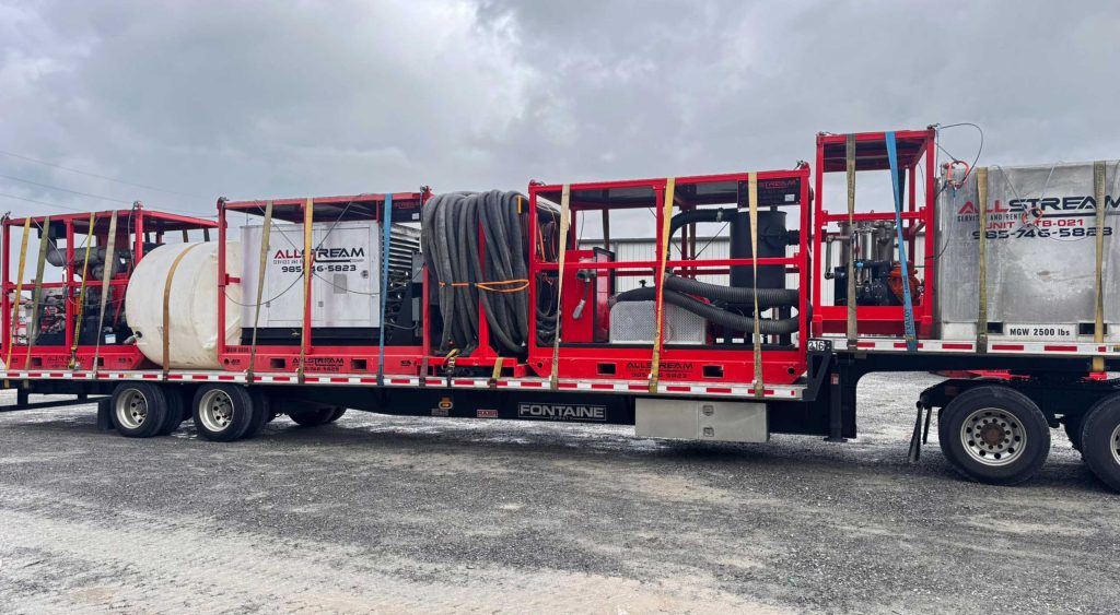 equipment securely loaded on a step deck trailer for transport from Houma, Louisiana, to Cushing, Oklahoma.