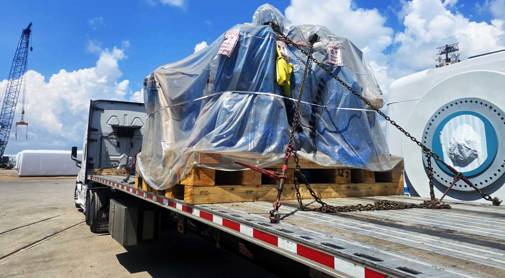 Heavy-duty flatbed hauling crane mats from Mississippi to Texas.
