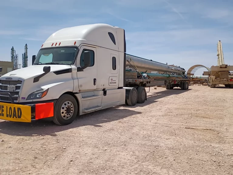 Oversized industrial pipe. Stretch flatbed at a construction site