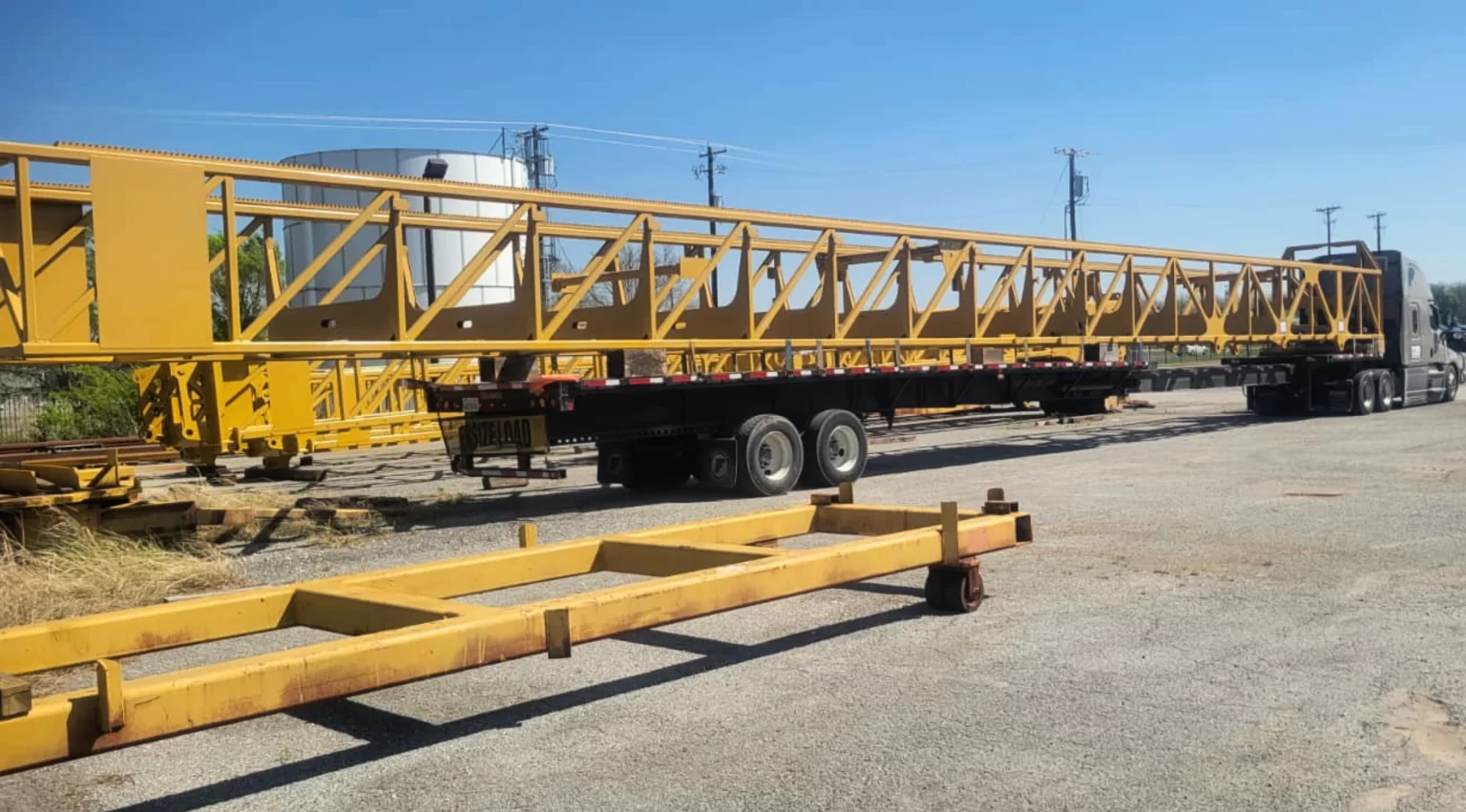 Extra-long fabricated steel structure. 114-foot mast on a stretch flatbed